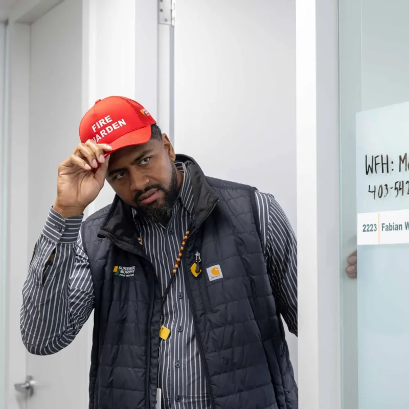 Fire warden at Surerus Murphy Joint Venture team's office, conducting a safety demonstration, highlighting corporate photography services and teamwork.