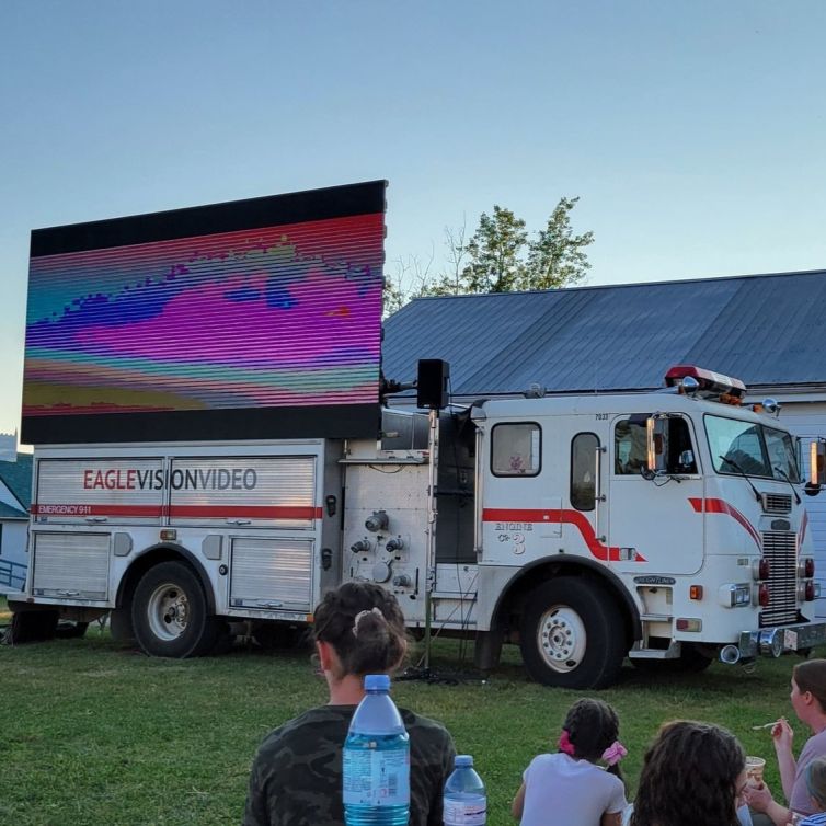 Community enjoying an outdoor movie night at Centennial Park.