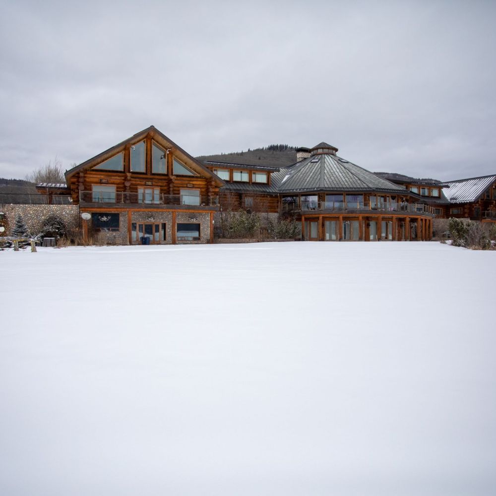 Log cabin photography for NBCTA highlighting traditional wood construction, architectural detail, and northern design craftsmanship.